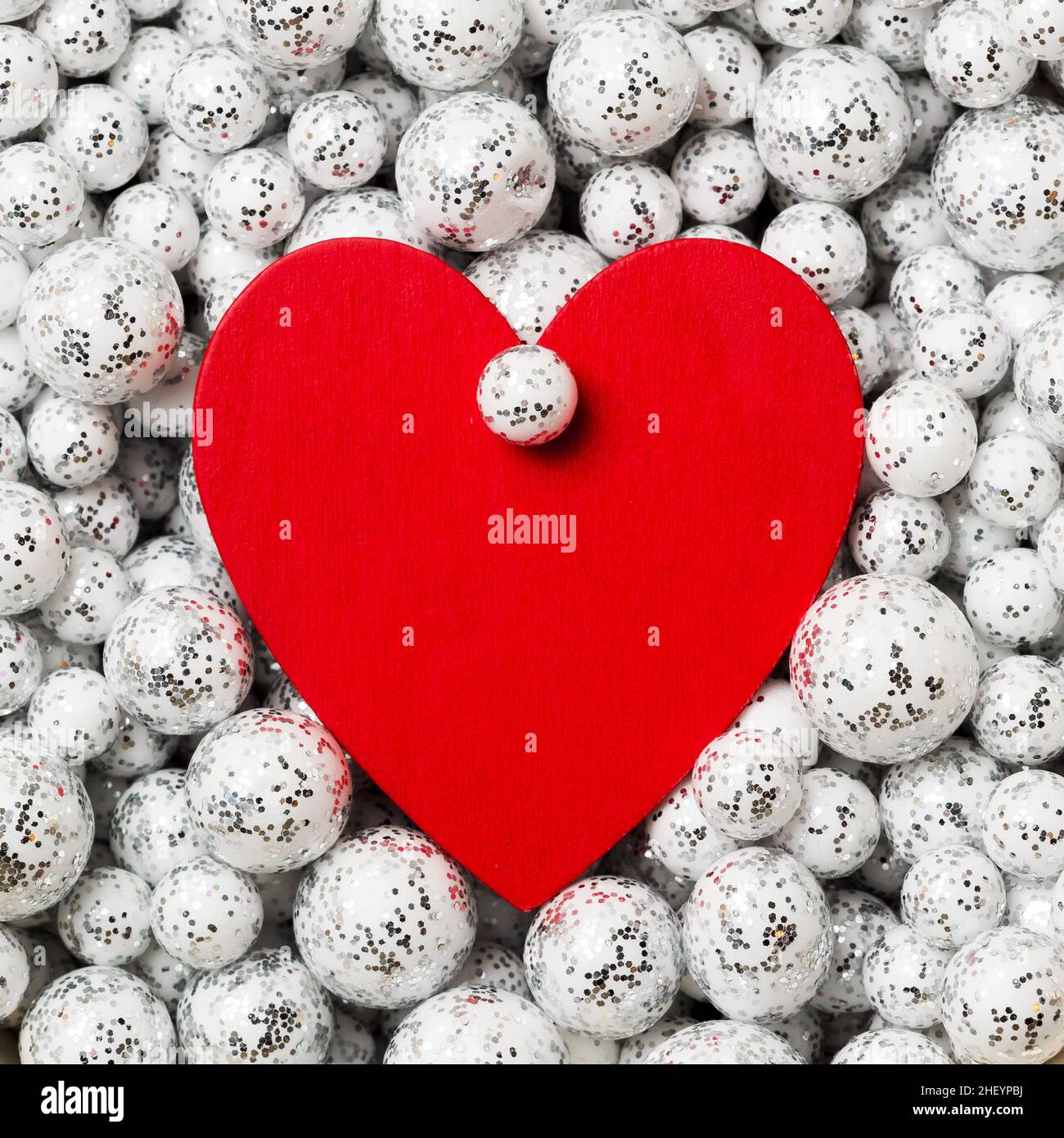 Saint Valentine`s day greeting card, big red heart in silver glitter balls, festive frame Stock Photo